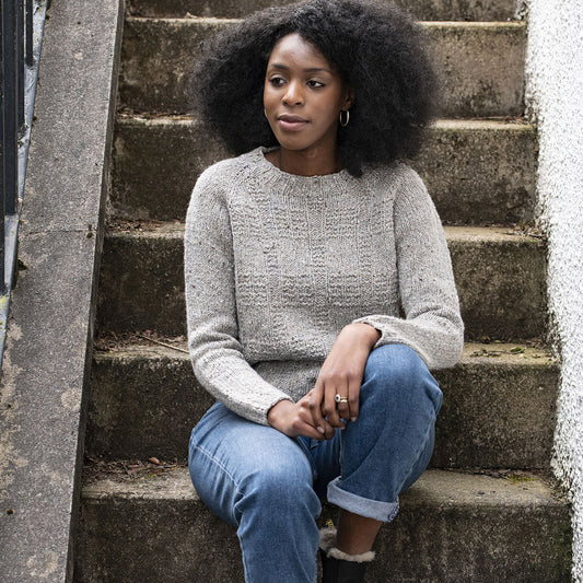 Tweed pullover with a textural plaid motif across the front body.